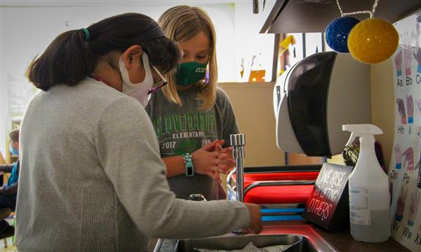 Students test aluminum boat in sink
